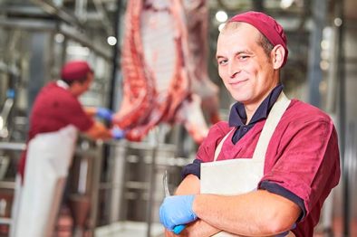 meat manufacturing factory. Portrait of young butcher
